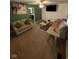 Inviting living room with cozy sofas, a large TV, and an open doorway leading to the kitchen at 4113 W 30Th St, Indianapolis, IN 46222