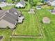 Aerial view of the property, showcasing the home, deck, storage shed, and well-maintained yard at 412 Sonhatsett Dr, Westfield, IN 46074