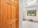 Bright bathroom with a large window, skylight, and a wooden door at 412 Sonhatsett Dr, Westfield, IN 46074