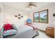 Comfortable bedroom with a ceiling fan and window view of the neighborhood at 412 Sonhatsett Dr, Westfield, IN 46074