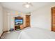 Bright bedroom with a TV, wood accents, and a view of the wooden door at 412 Sonhatsett Dr, Westfield, IN 46074