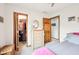 Well-lit bedroom with a view of the closet, a mirror, and a wooden door at 412 Sonhatsett Dr, Westfield, IN 46074