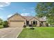 Charming brick home featuring a well-manicured lawn, attached garage, and inviting front entrance at 412 Sonhatsett Dr, Westfield, IN 46074