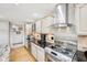 Well-lit kitchen featuring stainless steel appliances, granite countertops, and wood floors at 412 Sonhatsett Dr, Westfield, IN 46074