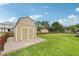 Backyard storage shed with double doors and concrete pad, providing ample space for tools and equipment at 412 Sonhatsett Dr, Westfield, IN 46074
