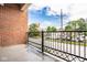 Brick balcony with metal railing offers a view of the surrounding street at 435 Virginia Ave # 106, Indianapolis, IN 46203