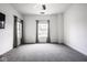 Spacious bedroom with neutral carpet, two windows, and ample natural light at 435 Virginia Ave # 106, Indianapolis, IN 46203