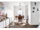Bright dining room with decorative light fixture, stylish furniture, and hardwood floors at 435 Virginia Ave # 106, Indianapolis, IN 46203