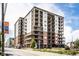 A modern condo building featuring balconies, brick accents, and beautifully maintained landscaping at 435 Virginia Ave # 106, Indianapolis, IN 46203