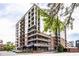 A contemporary condo building featuring multiple balconies and street-level retail space, with a tree adding natural beauty at 435 Virginia Ave # 106, Indianapolis, IN 46203