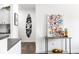 Stylish hallway with unique surfboard art leading to the kitchen at 435 Virginia Ave # 106, Indianapolis, IN 46203