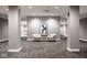A modern hallway features neutral colors, stylish seating, and an elegant textural wall design at 435 Virginia Ave # 106, Indianapolis, IN 46203