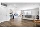 Open concept living space with kitchen bar, dining area, and hardwood flooring at 435 Virginia Ave # 106, Indianapolis, IN 46203