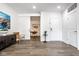 Bright living space featuring modern furnishings and a barn door leading to an office space at 435 Virginia Ave # 106, Indianapolis, IN 46203