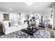 Open-concept living room with modern decor and a view into the kitchen and dining areas at 435 Virginia Ave # 106, Indianapolis, IN 46203