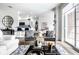 Stylishly staged living area with views of the kitchen and a slider leading to the outside at 435 Virginia Ave # 106, Indianapolis, IN 46203