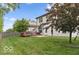 Spacious backyard with lush green grass, wood fence, and a pergola-covered deck perfect for outdoor entertaining at 4689 Muscatine Way, Westfield, IN 46062