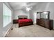 Spacious main bedroom with ceiling fan, a large window, and dark wood furniture at 4689 Muscatine Way, Westfield, IN 46062