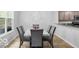 Open dining area showcasing a marble table, seating, natural lighting, and views of the outdoors at 4689 Muscatine Way, Westfield, IN 46062
