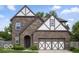 Charming brick home featuring a two-car garage, well-maintained lawn, and traditional architectural details at 4689 Muscatine Way, Westfield, IN 46062