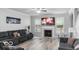 Cozy living room features a fireplace, a large TV, a reclining couch, and a view of a city-themed painting at 4689 Muscatine Way, Westfield, IN 46062