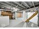 Unfinished basement with painted floor and exposed ductwork and utilities at 5148 Crittenden Ave, Indianapolis, IN 46205