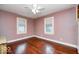 This cozy bedroom features hardwood floors, fresh paint, and a ceiling fan at 5148 Crittenden Ave, Indianapolis, IN 46205