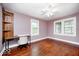 Bedroom with hardwood floors, natural light, and a built-in shelving unit at 5148 Crittenden Ave, Indianapolis, IN 46205