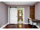 Cozy bedroom with ensuite access, a built-in shelf, and hardwood floors at 5148 Crittenden Ave, Indianapolis, IN 46205