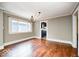 Dining room featuring hardwood floors, neutral walls, and a modern chandelier at 5148 Crittenden Ave, Indianapolis, IN 46205