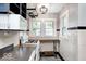 Bright kitchen featuring white appliances, open shelving, and a drop-in gas cooktop at 5148 Crittenden Ave, Indianapolis, IN 46205