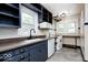 Well-lit kitchen with a window, white appliances, and plenty of storage at 5148 Crittenden Ave, Indianapolis, IN 46205