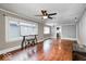 Open living room featuring hardwood floors, two windows, and neutral walls at 5148 Crittenden Ave, Indianapolis, IN 46205