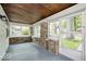 Enclosed porch with stone accents, plenty of windows, and wood plank ceiling at 5148 Crittenden Ave, Indianapolis, IN 46205