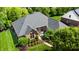 Aerial view of the property showcasing the home with mature trees, landscaping, and well-manicured lawns at 5350 Chico Grey Dr, Indianapolis, IN 46237
