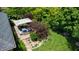 A patio area with a blue cushioned seating set around a fire table and a manicured lawn at 5350 Chico Grey Dr, Indianapolis, IN 46237