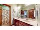 Bathroom with double sinks, a large mirror, and shower, offering convenience and functionality at 5350 Chico Grey Dr, Indianapolis, IN 46237