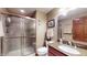 Well-lit bathroom featuring a glass-enclosed shower and vanity with a granite countertop at 5350 Chico Grey Dr, Indianapolis, IN 46237