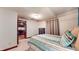 Bedroom featuring a queen-sized bed, neutral carpet, and ensuite access to the kitchen at 5350 Chico Grey Dr, Indianapolis, IN 46237