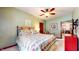 Comfortable bedroom with a ceiling fan, classic decor, and access to the dining room at 5350 Chico Grey Dr, Indianapolis, IN 46237