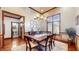 Formal dining room with hardwood floors, elegant lighting, and a classic table setting at 5350 Chico Grey Dr, Indianapolis, IN 46237