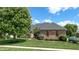 Well-maintained brick home showcasing lush landscaping, green lawns, and a charming exterior at 5350 Chico Grey Dr, Indianapolis, IN 46237