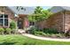 Charming brick home featuring a landscaped front yard with an American flag on display near the entrance at 5350 Chico Grey Dr, Indianapolis, IN 46237