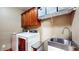 Well-equipped laundry room features cabinets, modern appliances, and a utility sink at 5350 Chico Grey Dr, Indianapolis, IN 46237