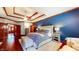 Spacious main bedroom with a tray ceiling, wood floors, and elegant furnishings with great natural light at 5350 Chico Grey Dr, Indianapolis, IN 46237