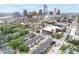 Expansive aerial view of the city showcases the townhouses and landscaped surroundings amid the downtown skyline at 536 Lockerbie S Cir, Indianapolis, IN 46202