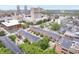 An aerial view of city neighborhood showing townhomes, trees, and city skyline in background at 536 Lockerbie S Cir, Indianapolis, IN 46202
