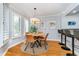 Bright dining area features a round wooden table, stylish chairs, and natural light from shuttered windows at 536 Lockerbie S Cir, Indianapolis, IN 46202