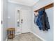 The home's entry foyer features a tile floor, coat rack, and adjacent sidelight window at 536 Lockerbie S Cir, Indianapolis, IN 46202