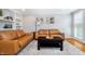 Inviting living room with tan leather sofas, built-in shelving, and a bright, neutral palette at 536 Lockerbie S Cir, Indianapolis, IN 46202
